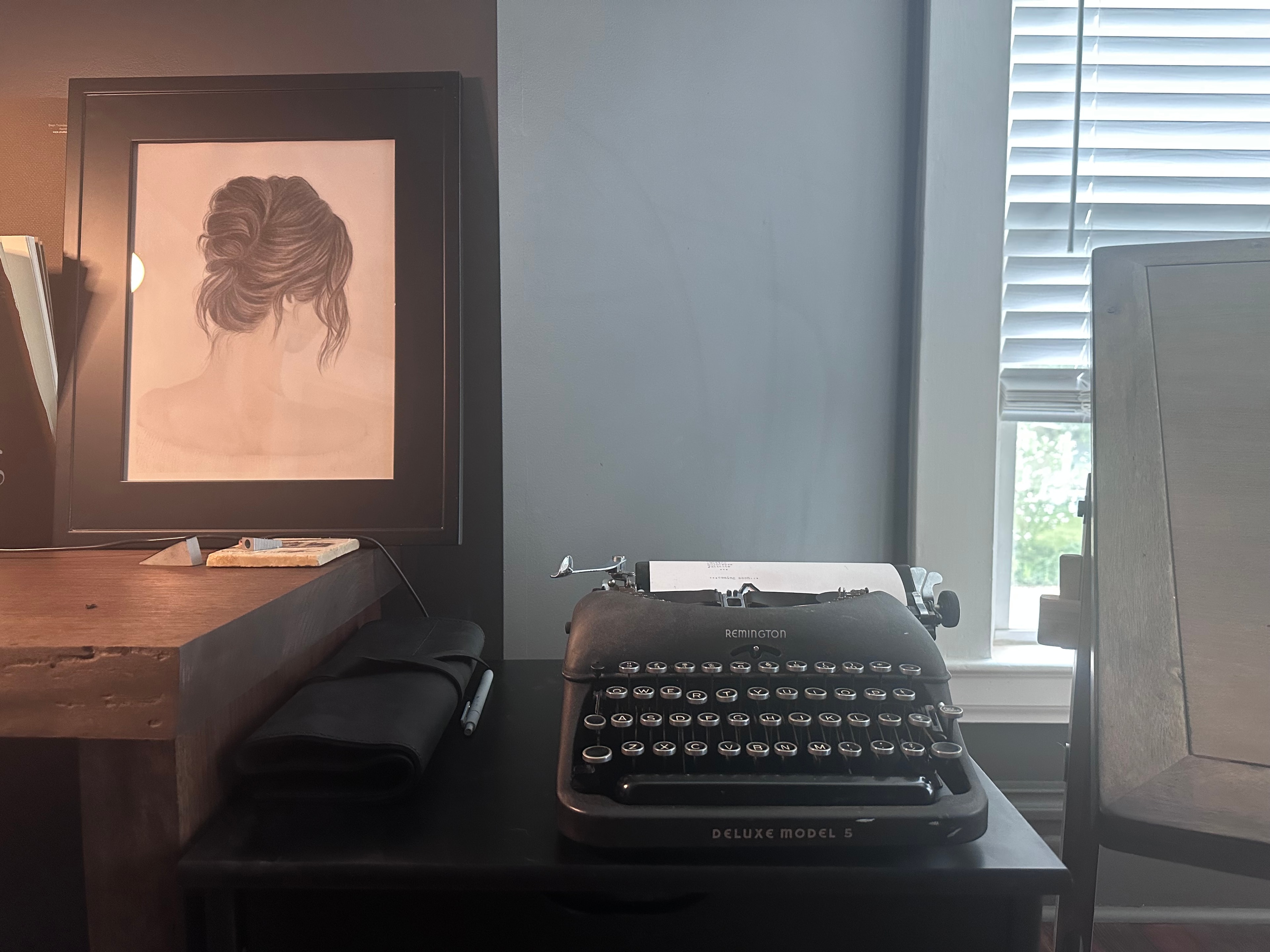 Studio interior with vintage typewriter and framed artwork